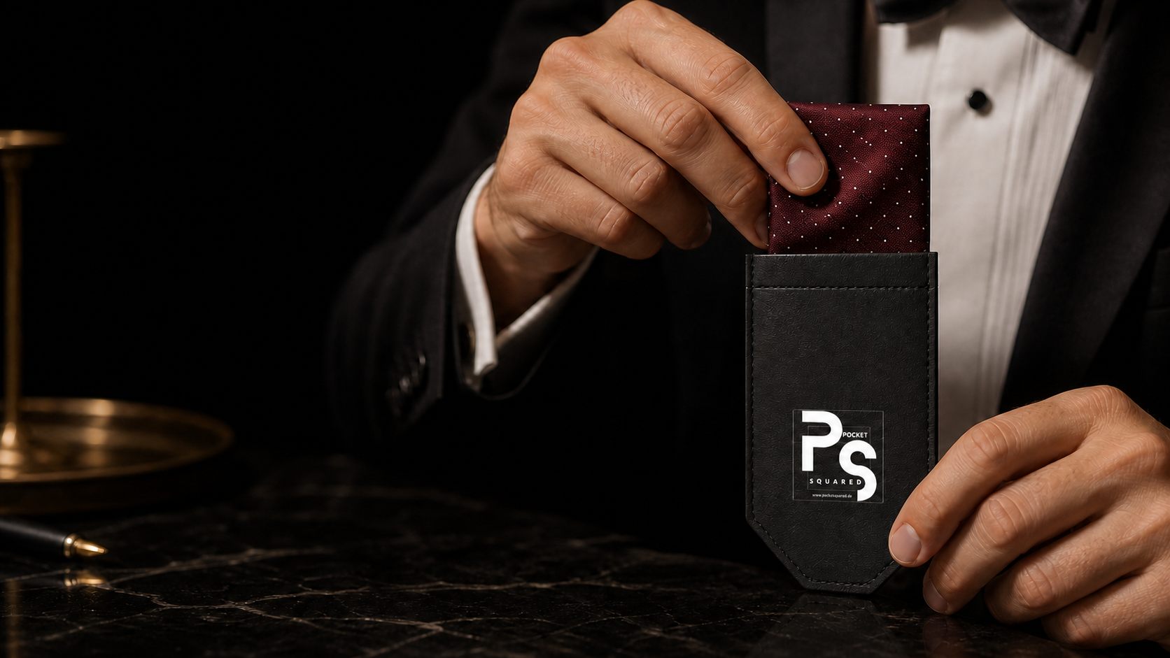 The burgundy micro-dot pocket square being loaded into the exact black Pocket Squared holder